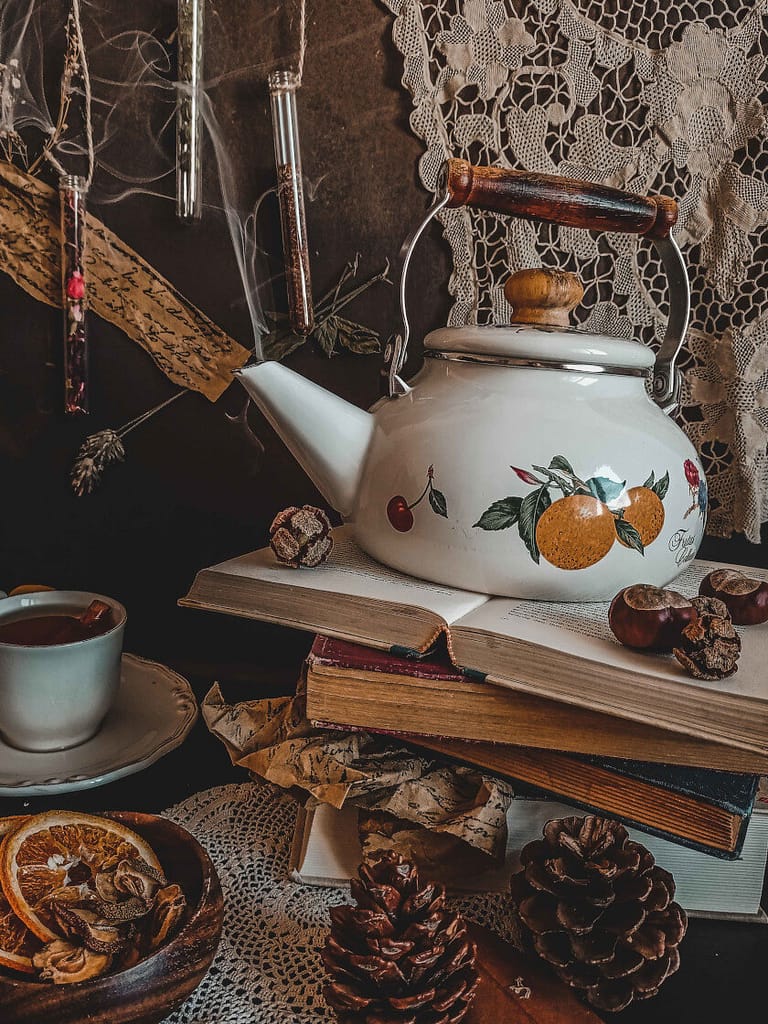 A teapot (the most important tea accessory used as a brewing vessel) sitting on some old books