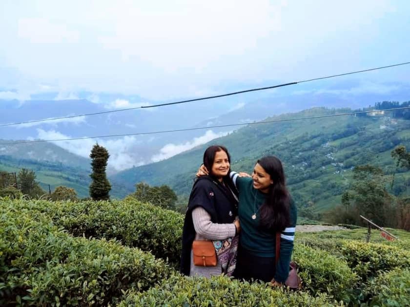 My mum and I in a Darjeeling tea plantation, feeling very fulfilled after drinking Darjeeling tea 
