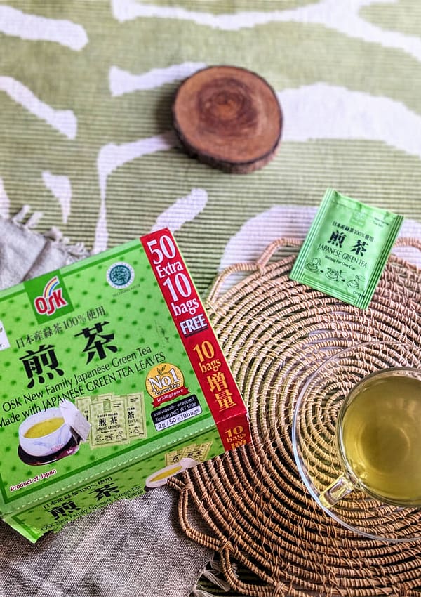 OSK Japanese green tea box next to a cup of OSK green tea