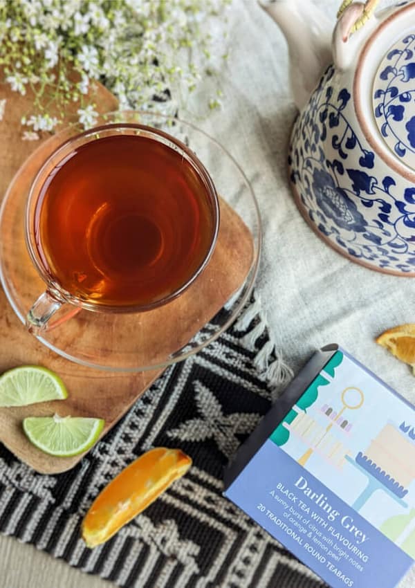 A cup of Whittard Darling Grey next to a box of Whittard Darling Grey teabags