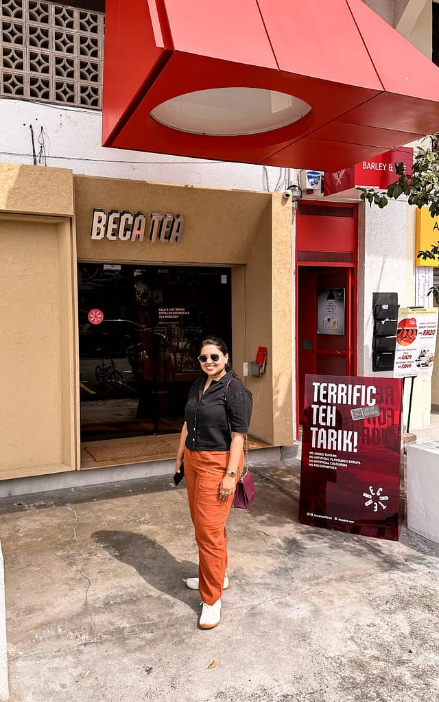 woman in front of Beca Tea entrance