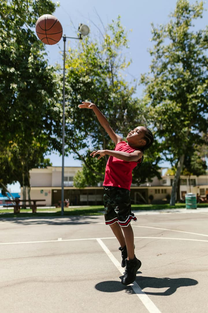 Boy playing basketball by performing wu-wei in Taoism