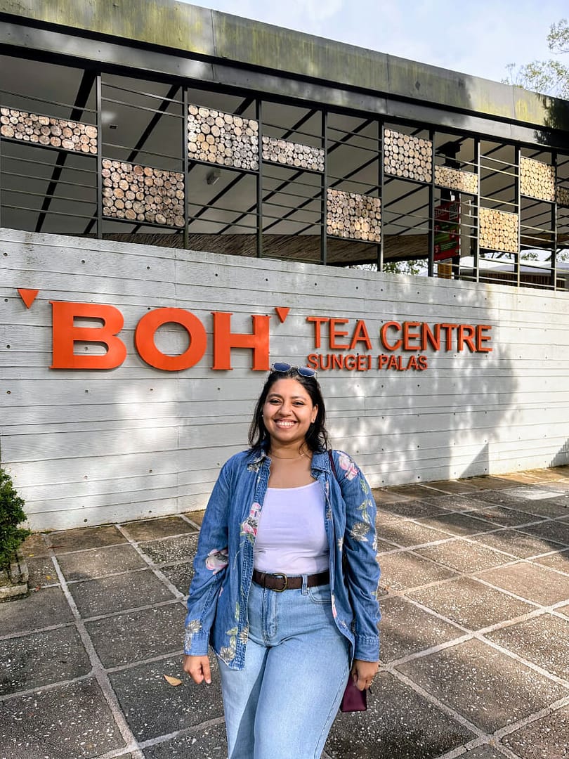 author in front of Boh Tea Center sign, an essential stop for a Cameron Highlands trip