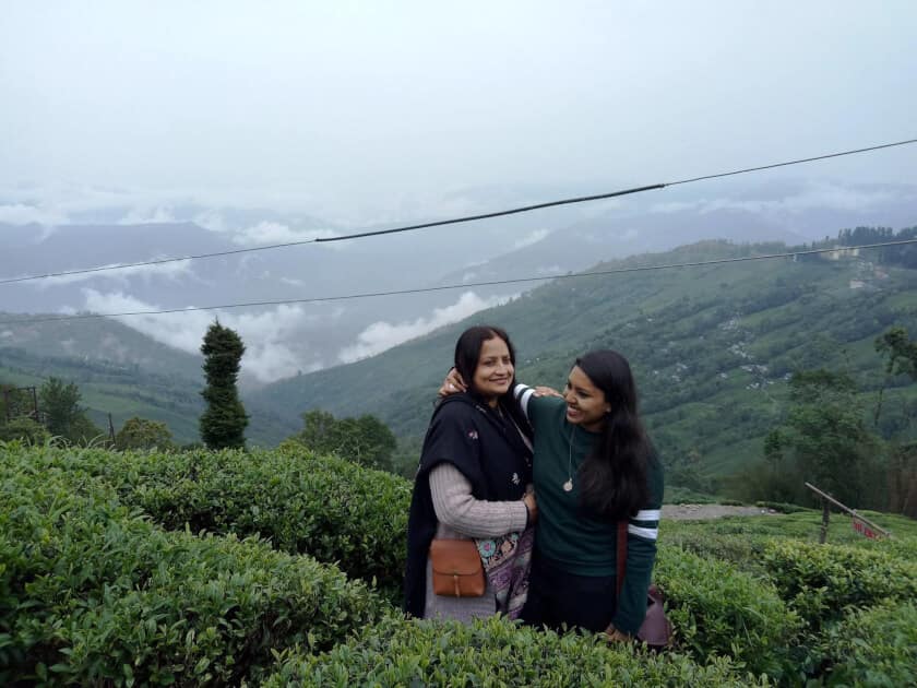 My mum and I in a Darjeeling tea plantation, feeling very fulfilled after drinking Darjeeling tea