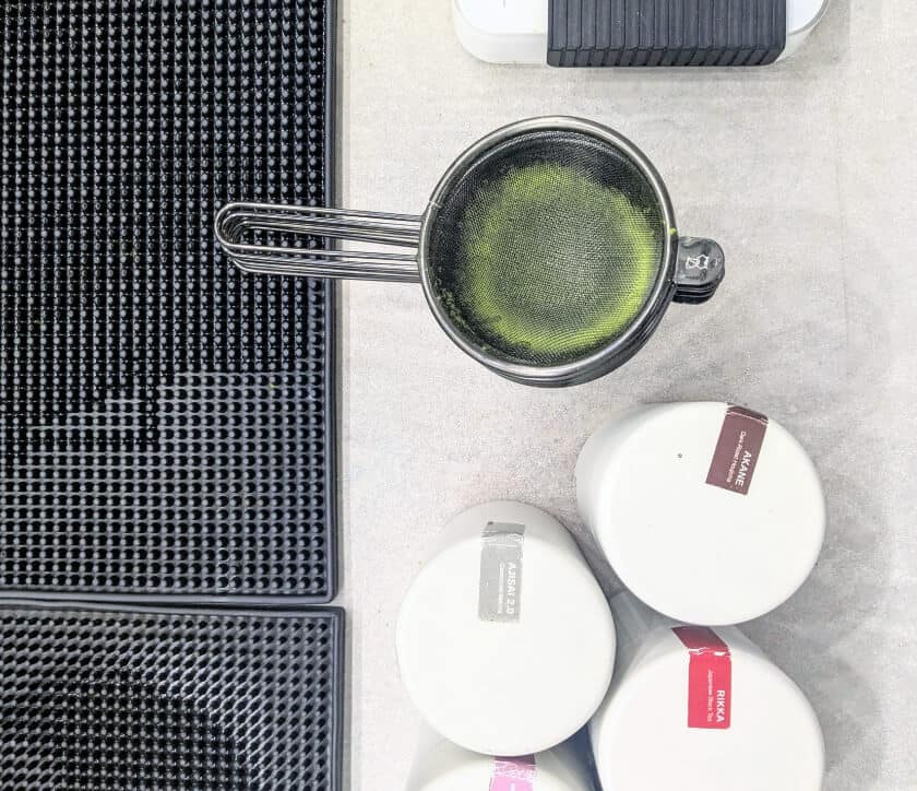Niko Neko's Matcha tins next to a used matcha sieve